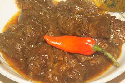 Bangladeshi/Bengali Food: Beef Bhuna (long-simmered dark beef) decorated with a Bombai morich chili 