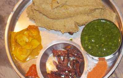 Nepali/Thakali Food: Dalbhat with buckwheat dumpling (phapar diro), dried meat (sukuti), taro vegetable and chili timur spice powder