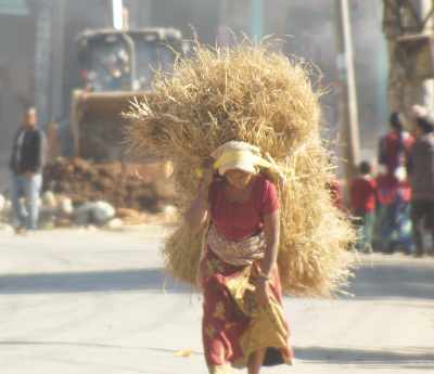 Woman carrying straw in Kushma, Nepal