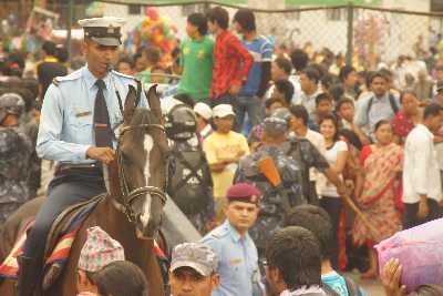 Mounted police managing the crowds during the Rato Machindranath Jatra festival in Patan, Kathmandu Valley, Nepal