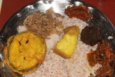 Indian / Khasi food: Brinjal (Aubergine), Muli (Radish), Tung-tap (chili paste), Meatball, Achar and a piece of boiled pork belly. 
