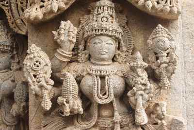 Statue of Godess Lakshmi holding fake corn cob (maize, Zea mays), Keshava Devalaya Temple, Somnathpur, Karnataka, India