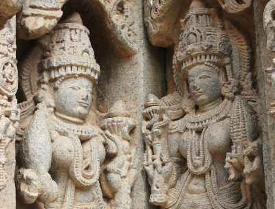 Pair of statues one of which holds fake maize (corn cobs, Zea mays), at Hoysala-style Keshava Devalaya Temple, Somnathpur, near Mysore, Karnataka, India