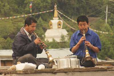 Trumpet blowers announcing a Buddhist temple ceremony in Tarke Ghyang, Helambu, Nepal