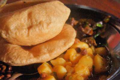 Nepali/Sherpa Food: Fried bread (puri) with chickpeas, potatoes and Skuti (dried buffalo meat)